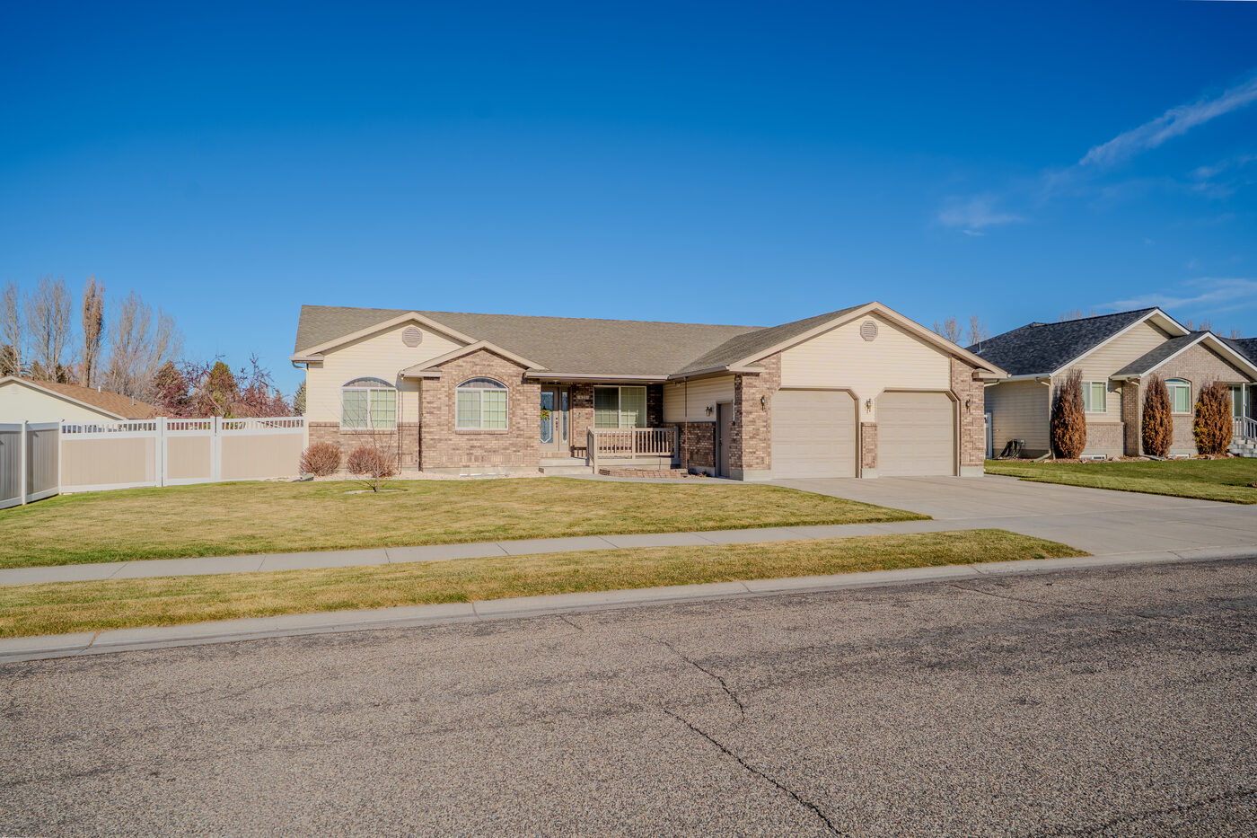 Alternate front exterior angle showing brick and vinyl siding — Hidden Valley Rexburg ID