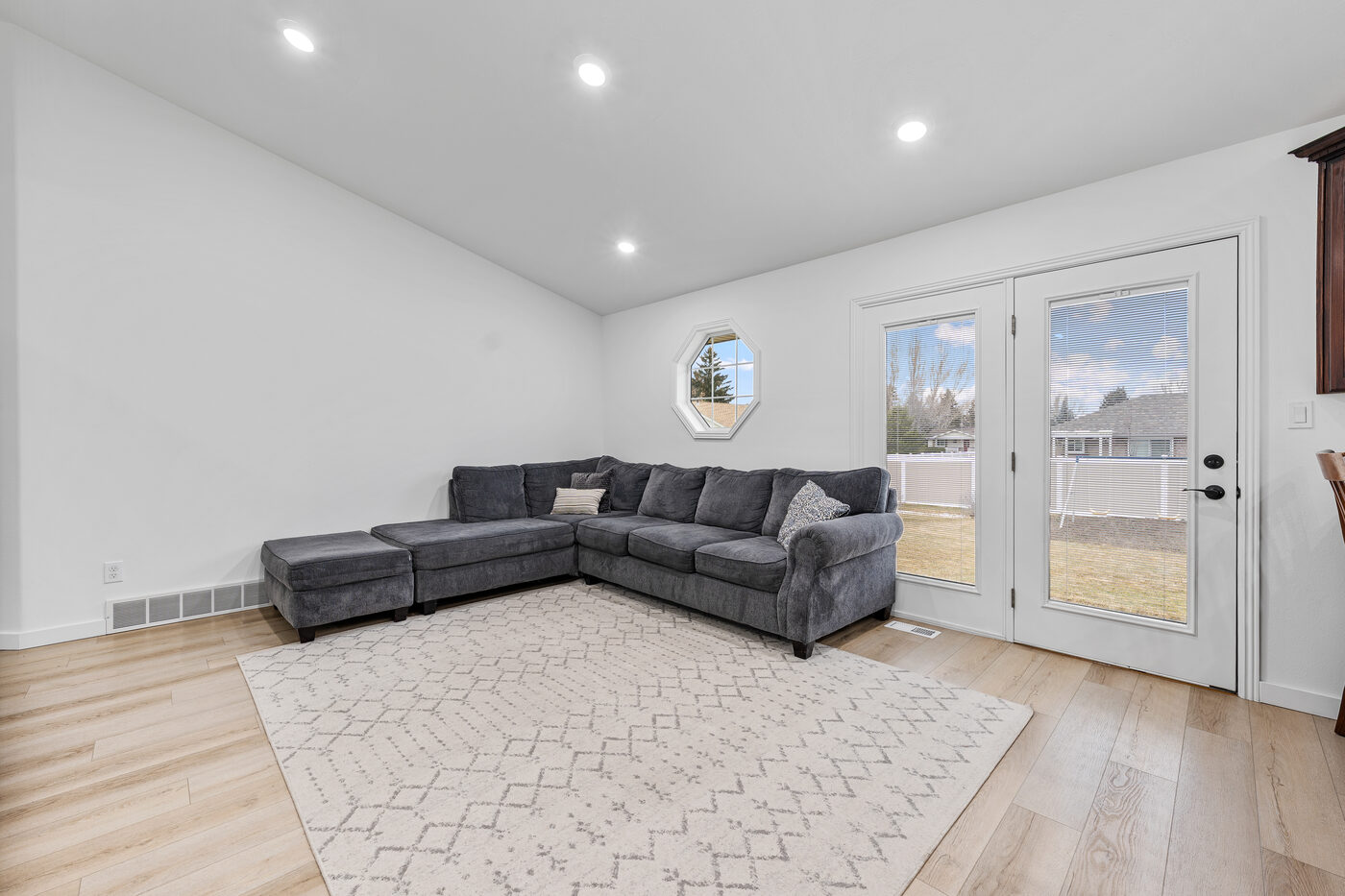 Living room with French doors and octagonal window at 625 Vale Lane Rexburg